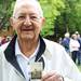 Staff Sgt. George Bigelow holds a picture of himself nearly 70 years ago in France. Bigelow was rescued by a tugboat on Christmas Eve after his troop transport ship was torpedoed in the English Channel in 1944. Ben Freed I AnnArbor.com
